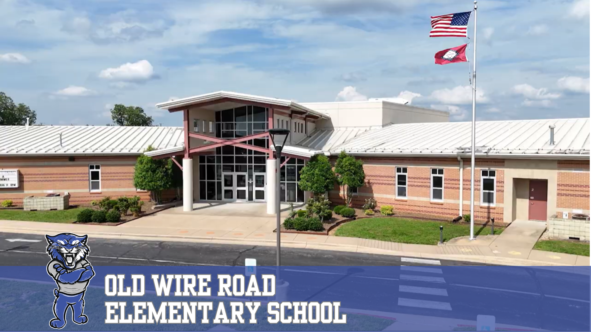 Exterior view of Old Wire Road Elementary School with its wildcat mascot and name.